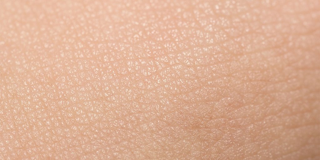 Nahaufnahme von menschlicher Hautoberfläche mit sichtbarer trockener Struktur.